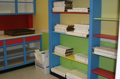 Colorful room at AL Credit Union with record books on shelves
